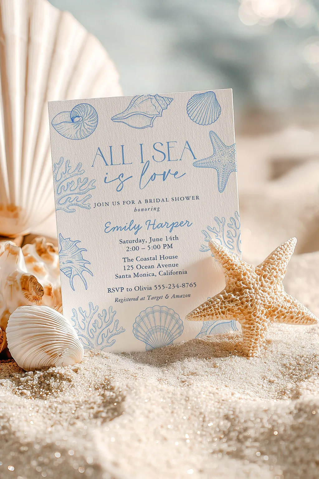 All I Sea Is Love bridal shower invitation — soft blue seashell illustrations and handwritten blue script on white