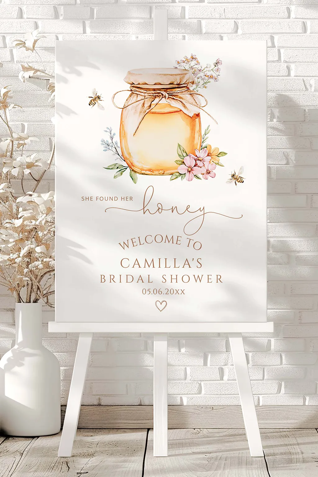 She Found Her Honey welcome sign on an easel with a small honey jar and baby's breath